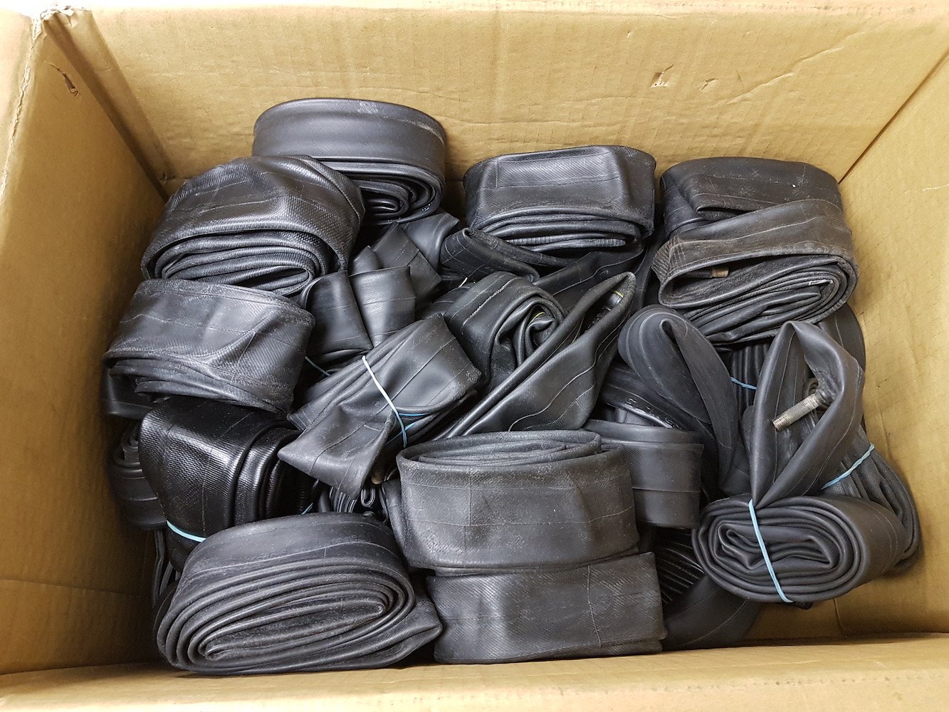 Many deflated inner tubes in a box